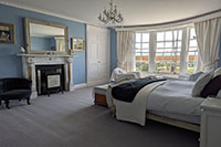 Blue Bedroom with original Regency fireplace and upholstered French bed