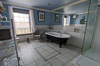 Bathroom with roll top bath and power shower