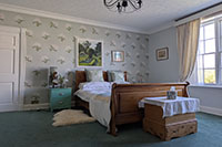 Green Bedroom with sleigh bed and original art